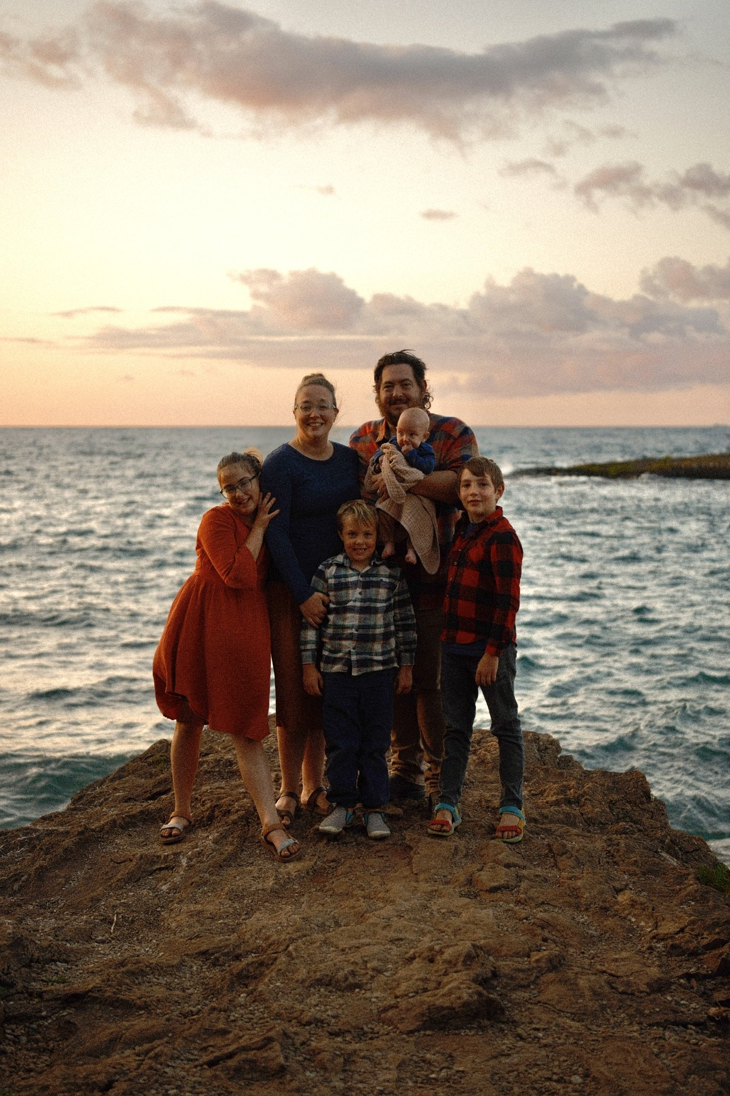 Josh LeClair with his family on the rocks at sunset
